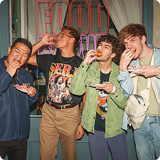 Four Food Bowl attendees simultaneous taking bites and sips of their food